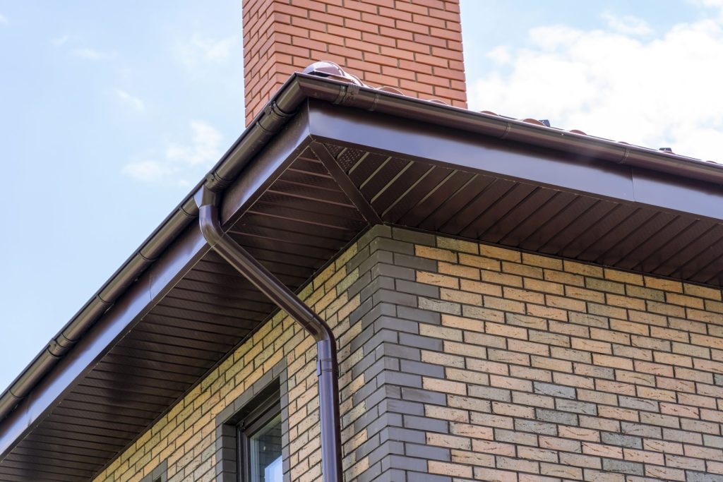 A brick house with a dark brown soffit system